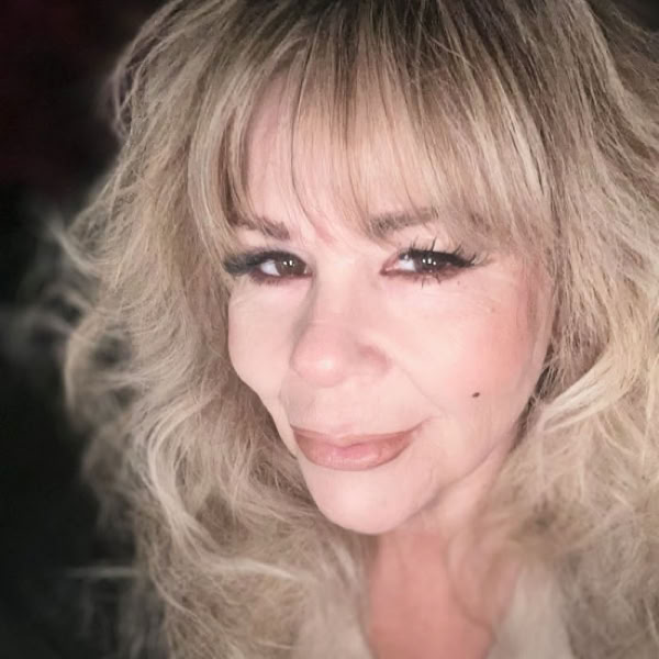 A mysterious sorceress poses with candles, evoking an enchanting and gothic vibe.