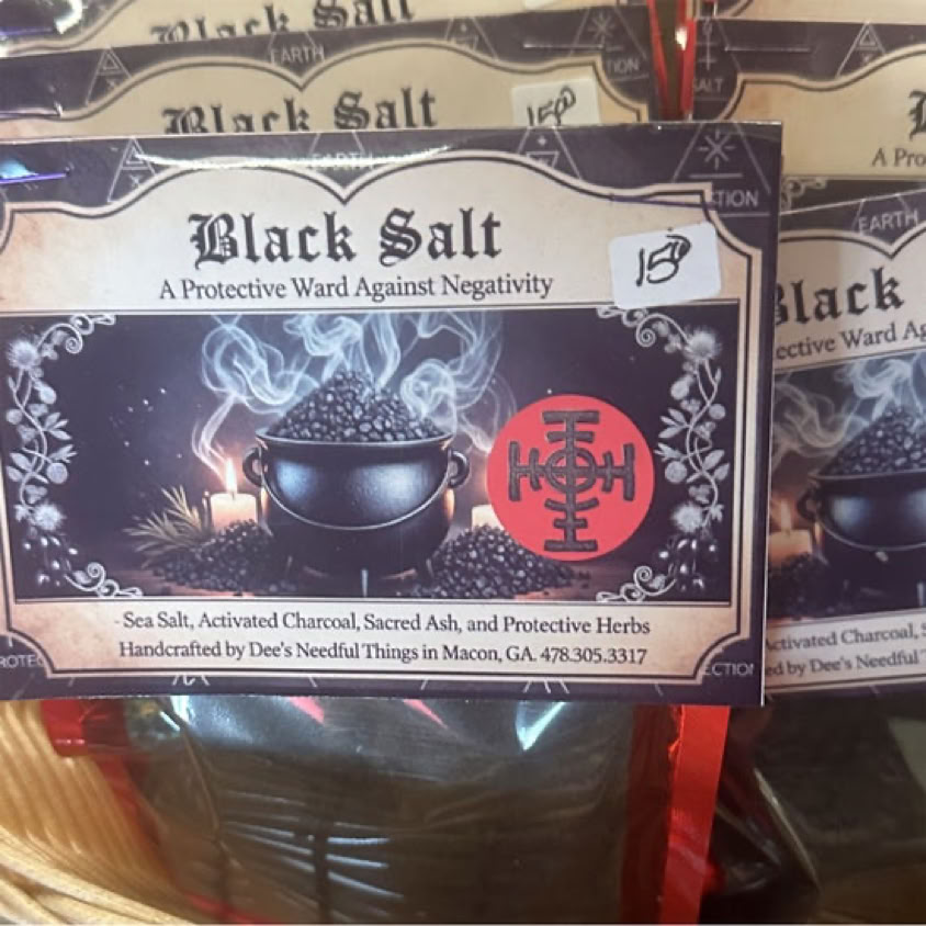 Hand snuffing a candle with elegant candlestick, smoke rising in a moody indoor setting.